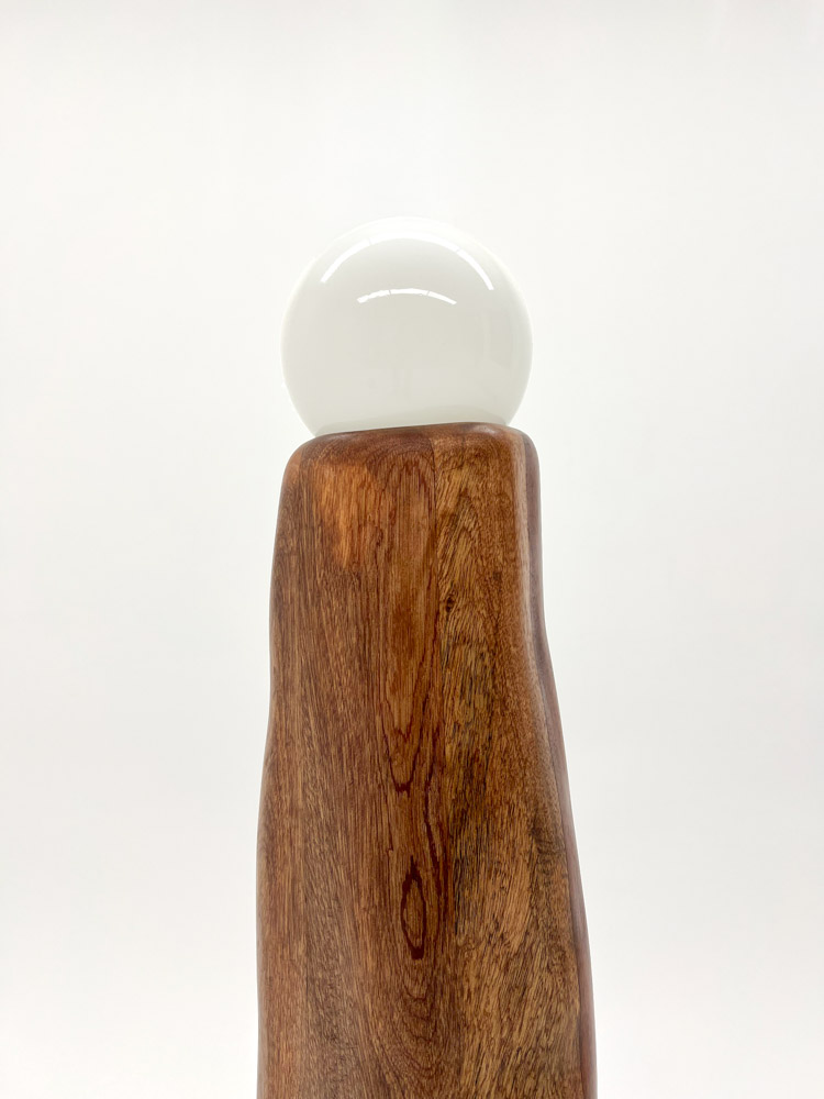 Close up of the top of Lampe Cheminée by Camille Tan, solid Sapele wood and glass 
